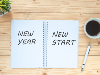 Photo of notebook on top of table with writing New Year, New Start